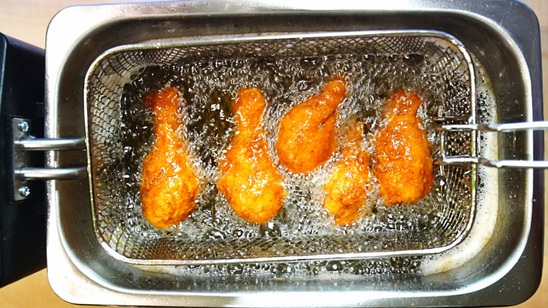 Deep frying chicken drumsticks 
