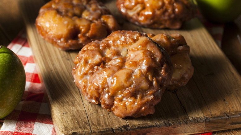 Apple fritters on a bread board