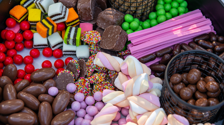 A platter of Australian sweets including Musk Sticks, licorice, and chocolate covered nuts