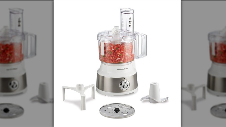 Hamilton Beach 10-Cup Food Processor filled with chopped tomato and with different parts around it