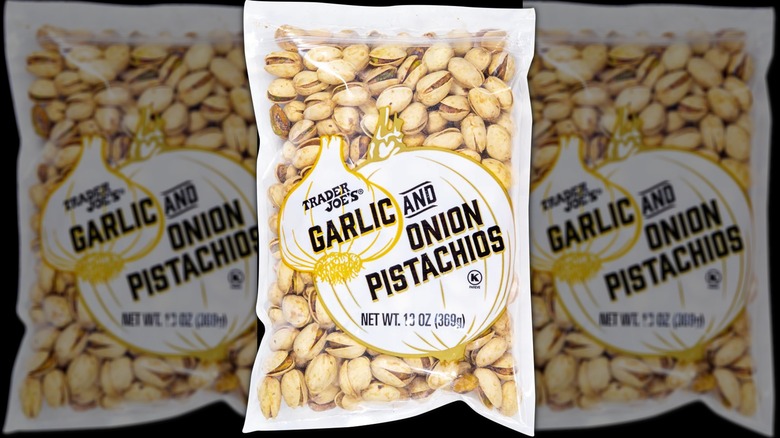 A bag of Trader Joe's garlic and onion pistachios on a black background