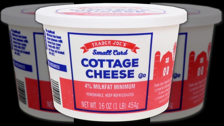 A container of Trader Joe's small curd cottage cheese on a black background