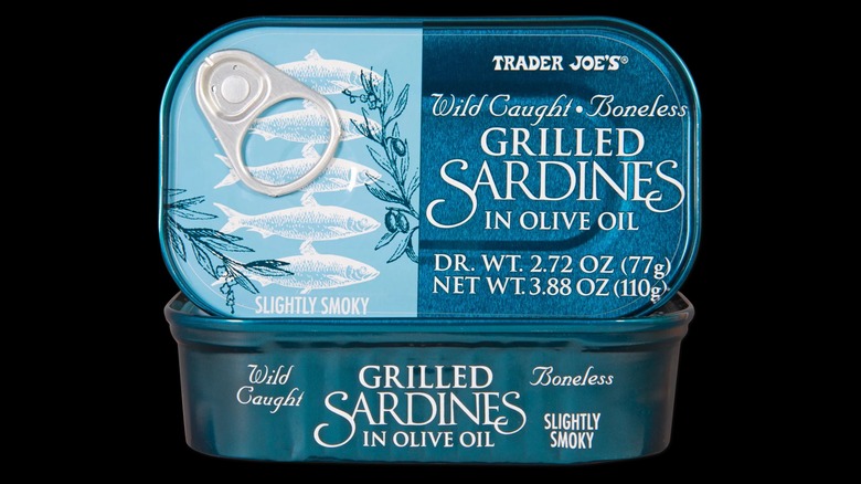 A tin of Trader Joe's grilled sardines in olive oil on a black background