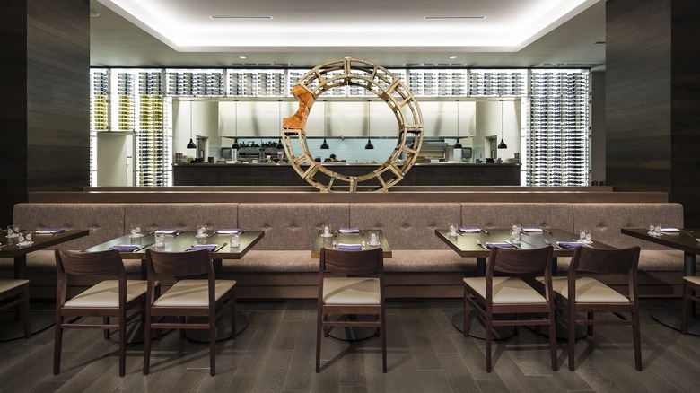 Interior of Cedar + Stone, Urban Table showing seating, an art piece, and the bar