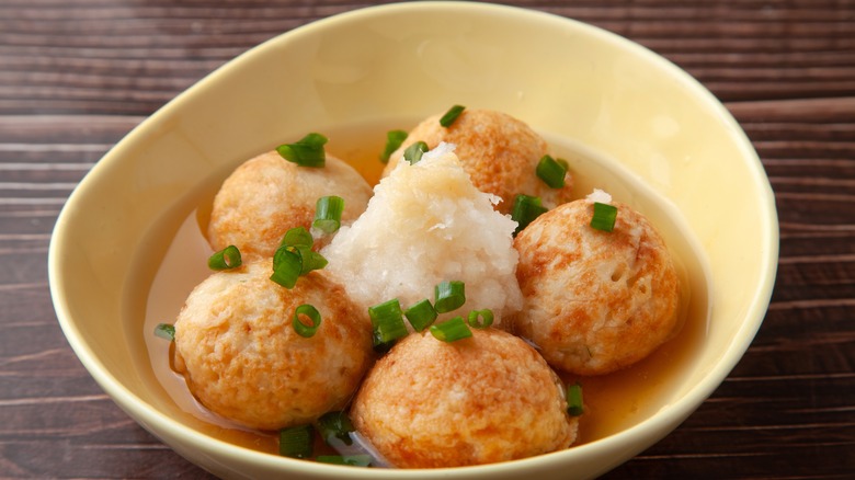 Bowl of takoyaki with sauce