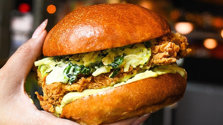 Fried chicken sandwich in hand