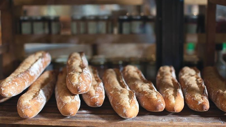 Rows of rustic bread loaves on shelf