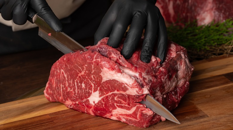 Butcher cutting steak