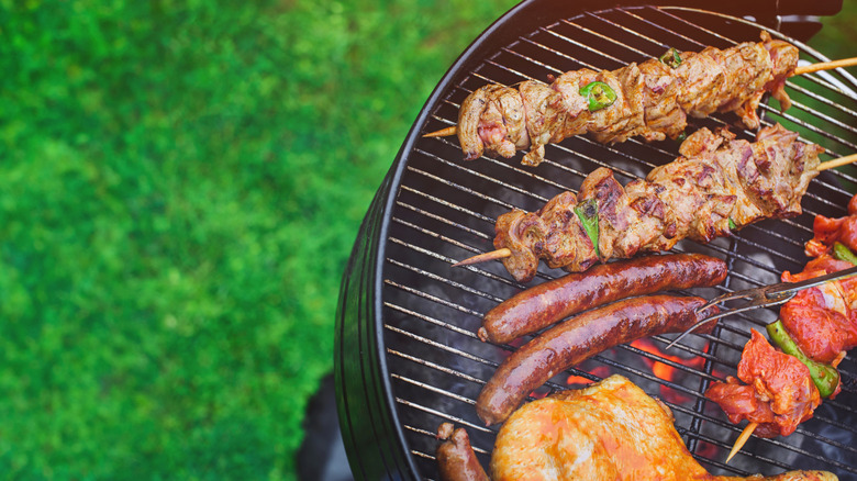 Various meats cooking on grill