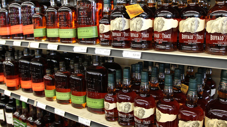 Different types of whiskey on display in store