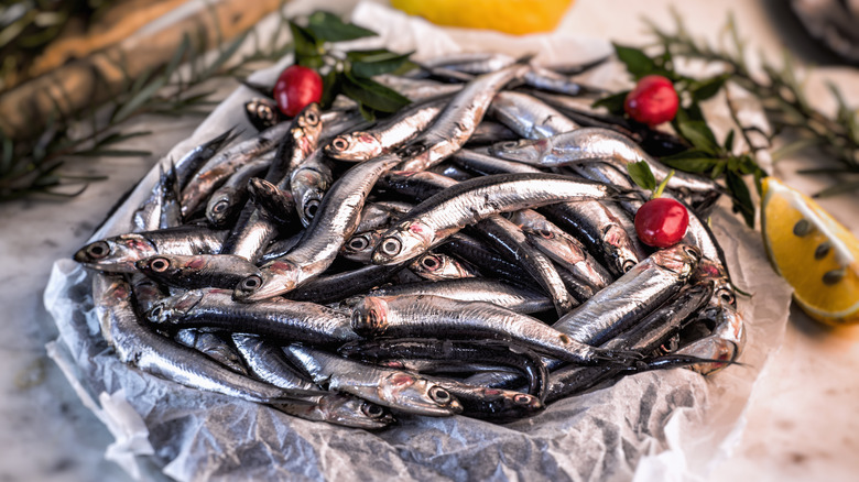 A bowl of fresh, whole anchovies