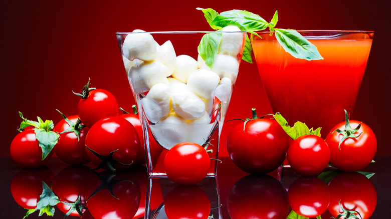 A glass of soft mozzarella balls, a Bloody Mary, and tomatoes