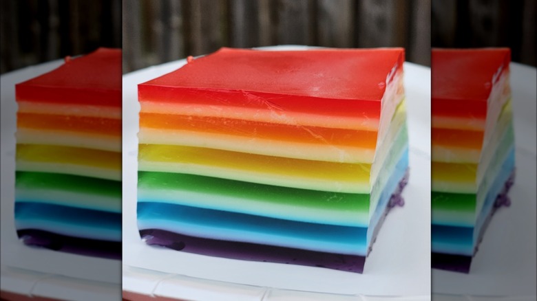A layered Jello salad slice on a white plate