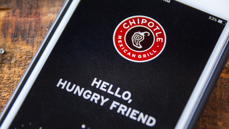 Close-up of chipotle app on phone sitting on a table