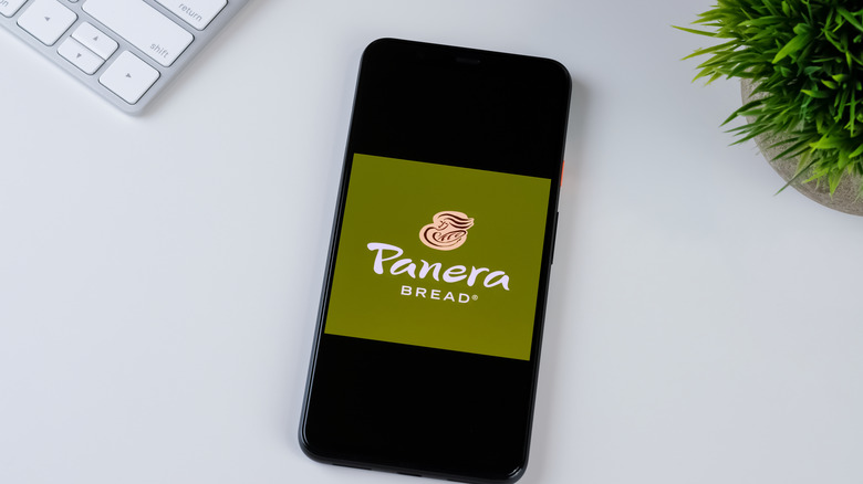 Panera Bread app on a phone sitting on a white table