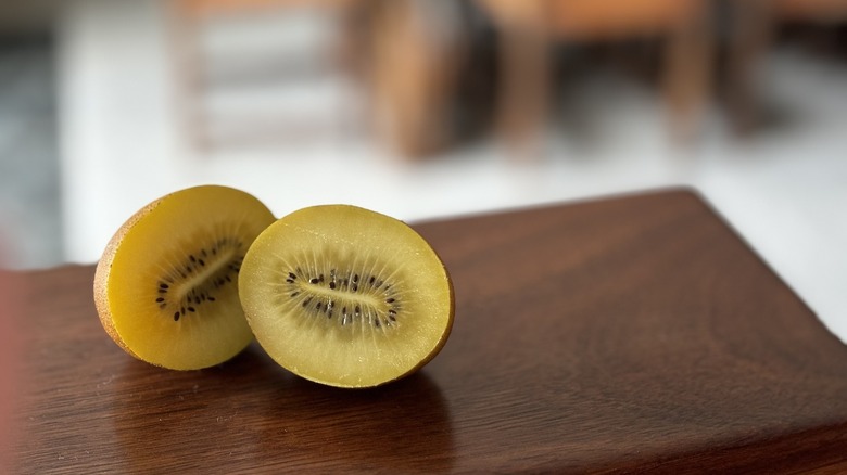 gold kiwi sliced in half sitting on bar