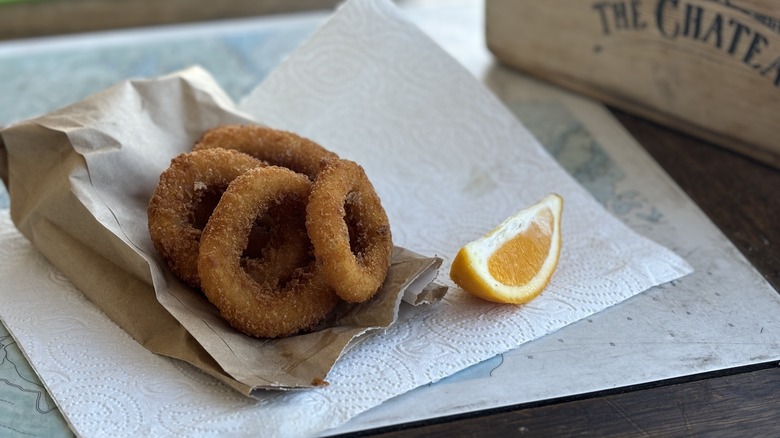 deep-friend calamari rings on paper bag