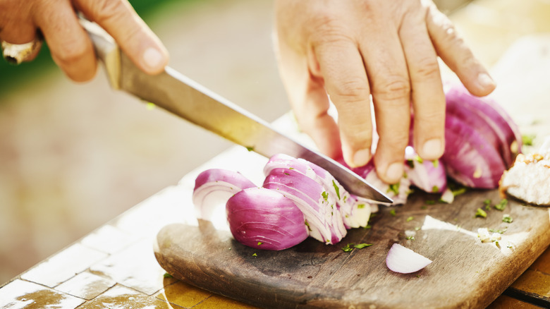 man chopping onion