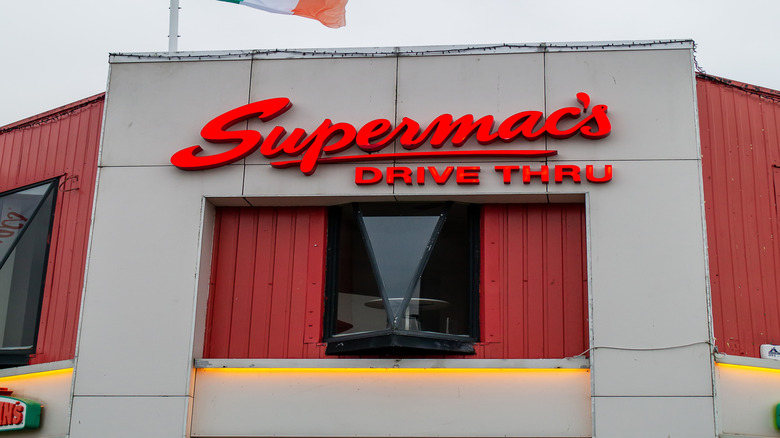 Supermac's storefront in Ireland with an Irish flag flying above