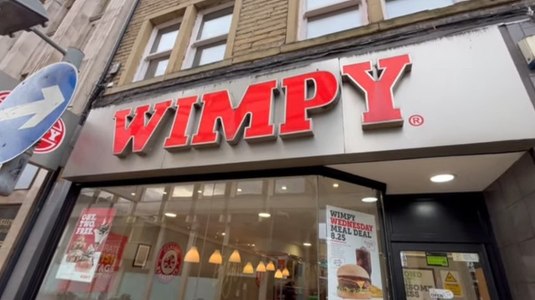 Wimpy sign in red on storefront with sale signs in window