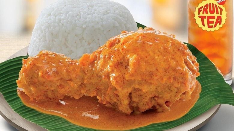 A piece of Ayam McD Gulai with rice and Sosro Fruit Tea from McDonald's in Indonesia