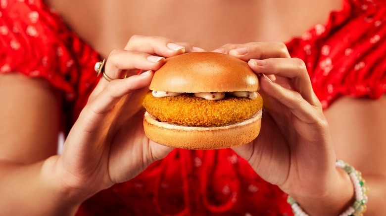 A person holding a McKroket burger from McDonald's in The Netherlands