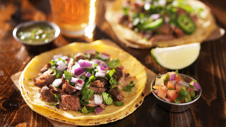 Mexican barbacoa tacos with red onions and pico de gallo