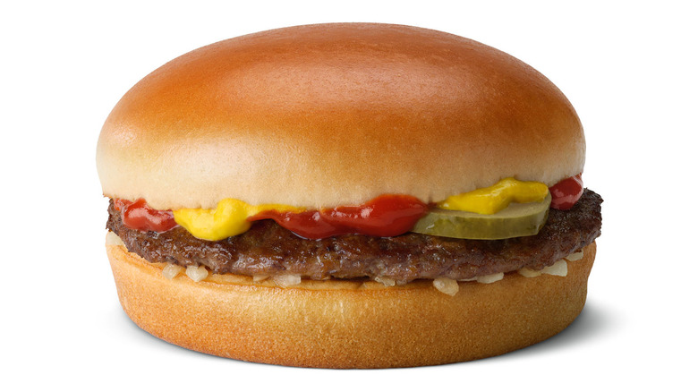 A McDonald's classic hamburger with ketchup, onions, pickles, and mustard