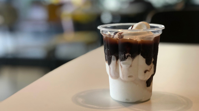 A McDonald's hot fudge sundae in a plastic cup