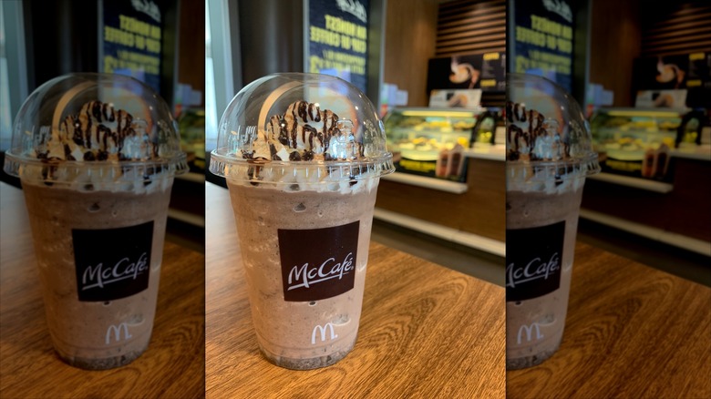 A McDonald's Mocha Frappe in a plastic cup on a table