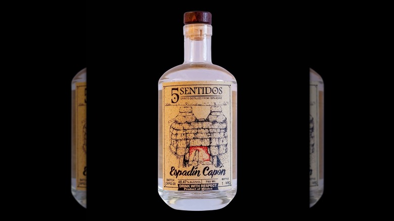 A bottle of 5 Sentidos Espadín Capón mezcal