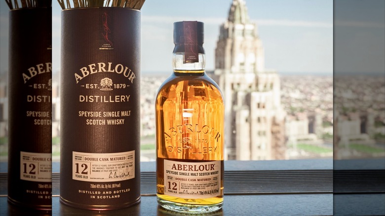 A bottle of Aberlour 12 Double Cask Matured Single Malt Whisky beside its canister