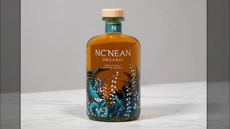 A bottle of Nc'Nean Organic Single Malt Scotch Whisky on a counter