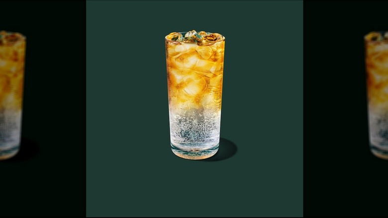 Tropical Citrus Iced Energy in a glass cup on a green background