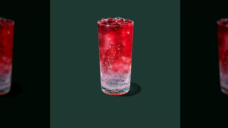 Melon Burst Iced Energy in a glass cup on a green background