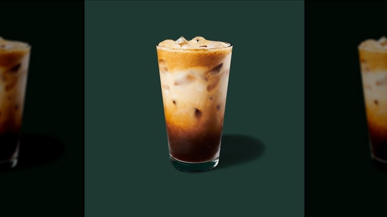 Iced Brown Sugar Oatmilk Shaken Espresso in a clear glass on a green background