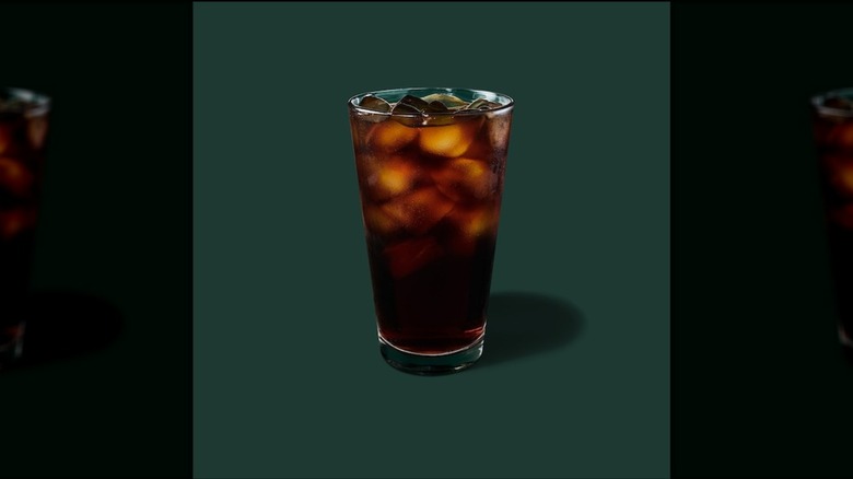Unflavored cold brew in glass on a green background