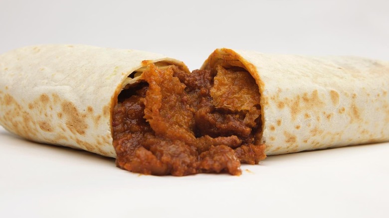 A beef chicano-style burrito from Lupe's on a white background