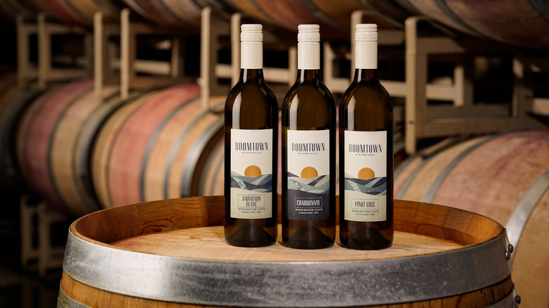 Three bottles of Boomtown wine on barrels