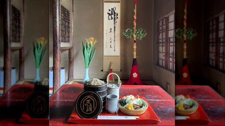 A bowl of soba noodles and sides on a table in Honke Owariya in Kyoto, Japan