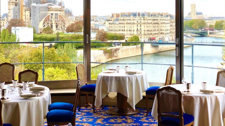 The dining room of La Tour d'Argent with views of Notre Dame Cathedral from the windows