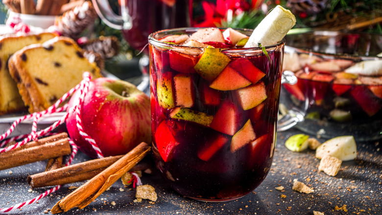 A glass of ponche Navideño with fruit and cinnamon