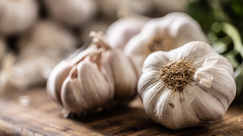 unpeeled garlic cloves on board