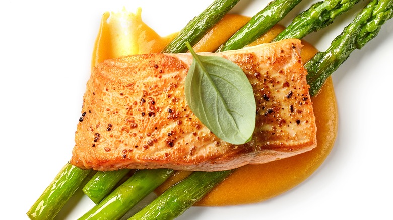 salmon with asparagus on plate