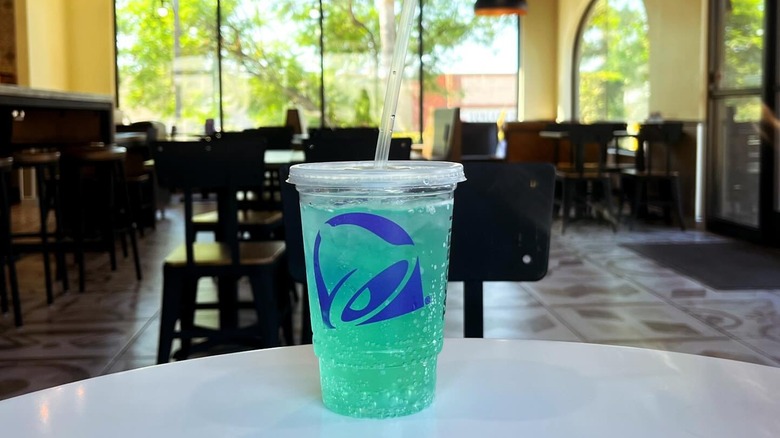 plastic cup of Baja Blast on a table at Taco Bell