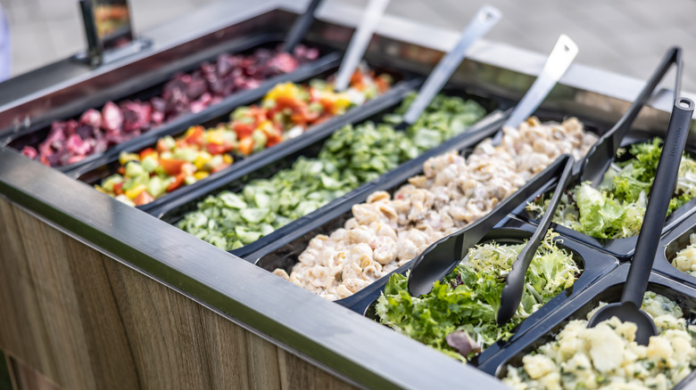 Salad bar at a fast food restaurant with salads and pasta