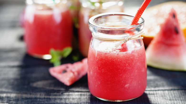 watermelon juice with jars behind