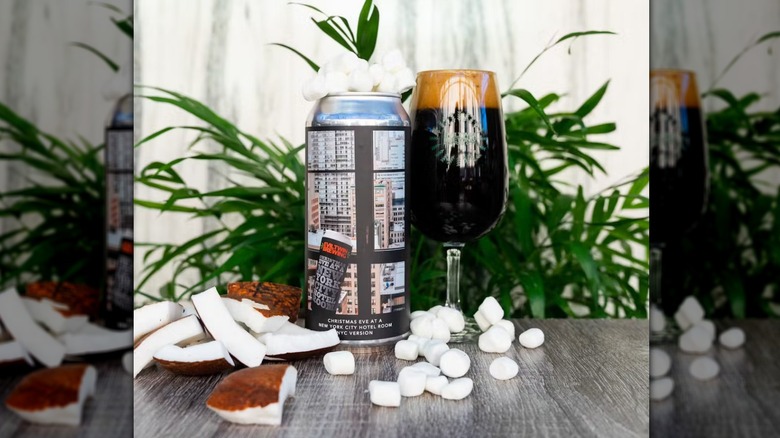 A can and glass of Evil Twin Brewing Christmas Eve at a New York City Hotel Room with marshmallows and coconut