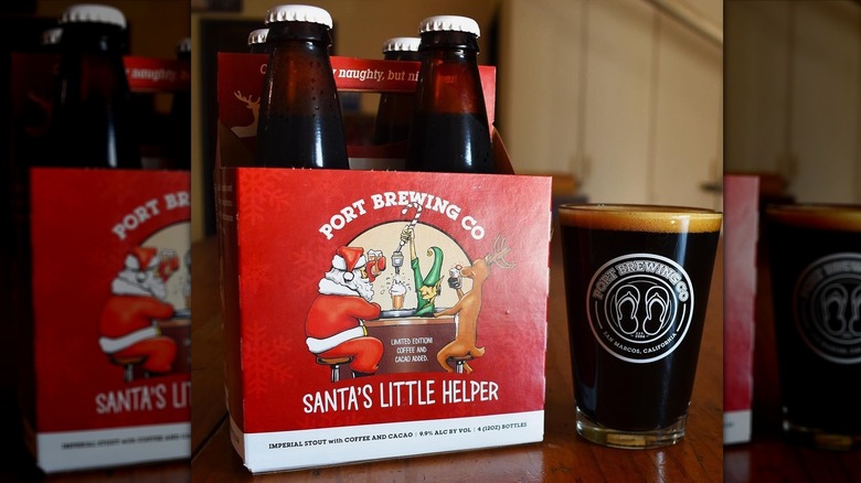 A case of Port Brewing Santa's Little Helper stout beer with a full glass of beer