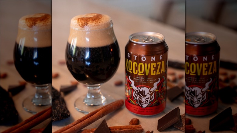 A glass and can of Stone Brewing Xocoveza Imperial Stout